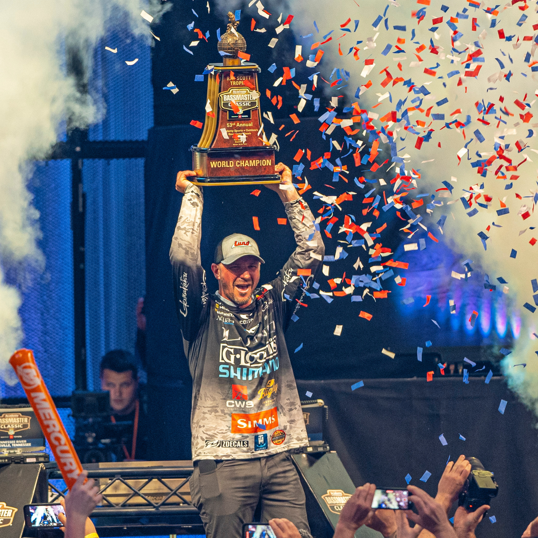 Bassmaster Classic champion Jeff Gustafson celebrates with the championship trophy after his tournament victory.